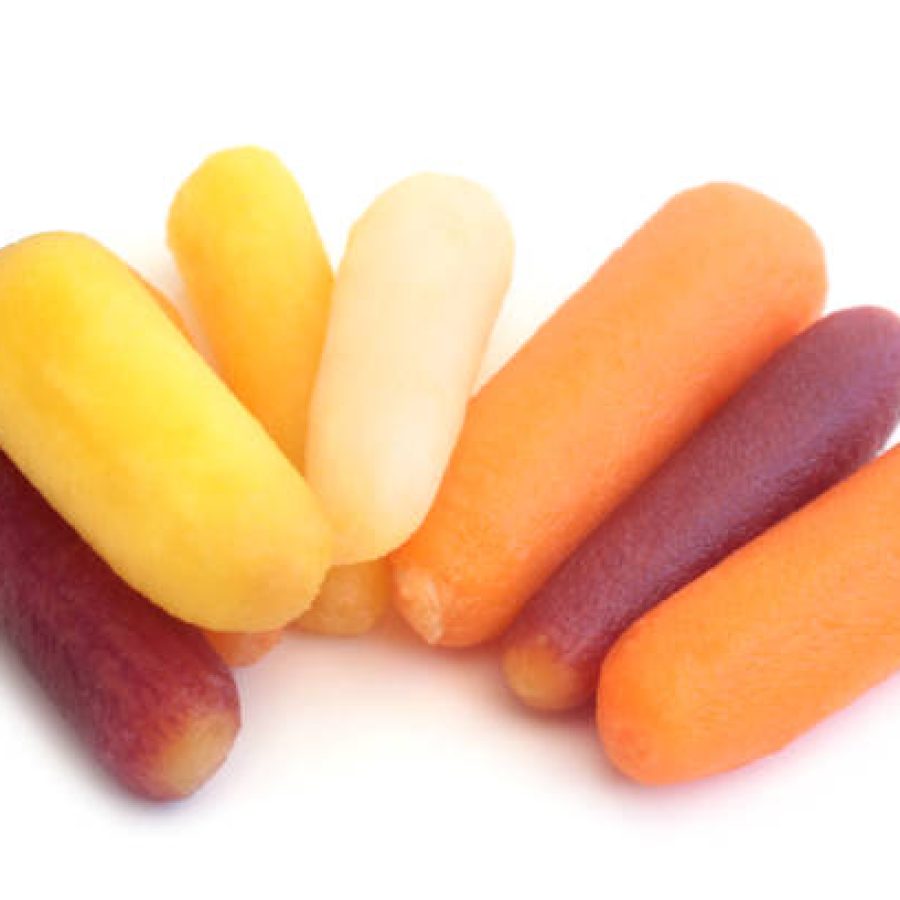 Baby rainbow carrots on white background