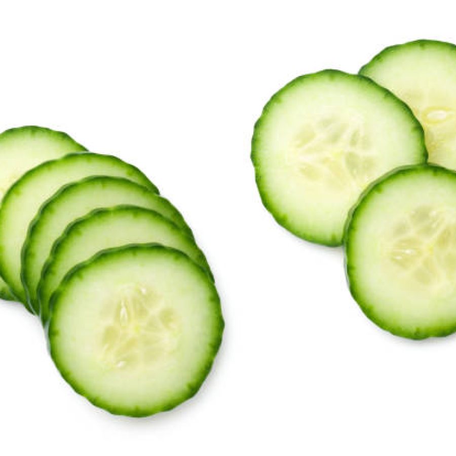 Cucumber slice isolated on white background. Light shadow. Top view, flat lay