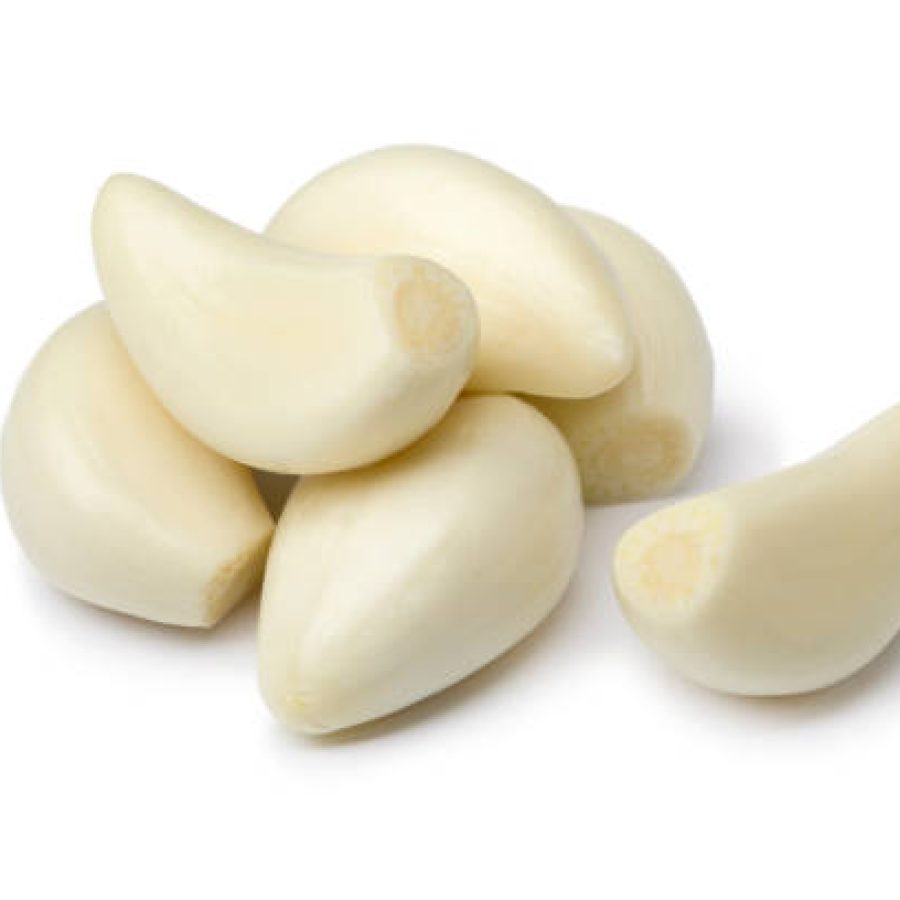 Fresh whole peeled garlic cloves isolated on white background