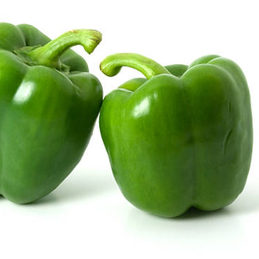 Two green bell peppers isolated on a plain white background, with shadows underneath.