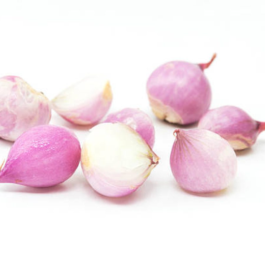 peeled shallots on white background