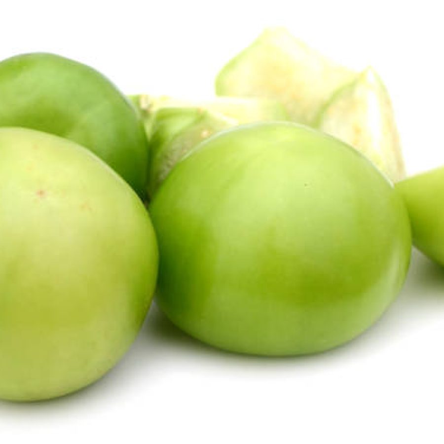 cut peeled and whole tomatillo isolated on white